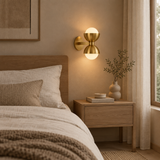 Gold brass glass wall lamp in a warm Japandi bedroom