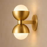 Gold brass glass wall lamp close-up showing brushed metal and frosted glass