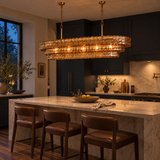 120 cm Étoile Vintage French Amber Glass Chandelier glowing warmly above a marble kitchen island with navy cabinetry.