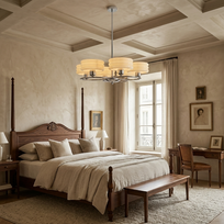 A luxury bedroom featuring a dark wood four-poster bed with beige linens, a matching wooden bench at the foot of the bed, a modern multi-light chandelier, and a cozy desk setup by a window.