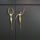 Gold decorative handles on a dark cabinet