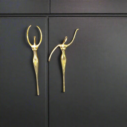 Gold decorative handles on a dark cabinet