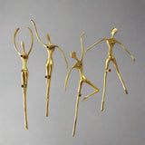 Set of gold cabinet handle figurines on a white background