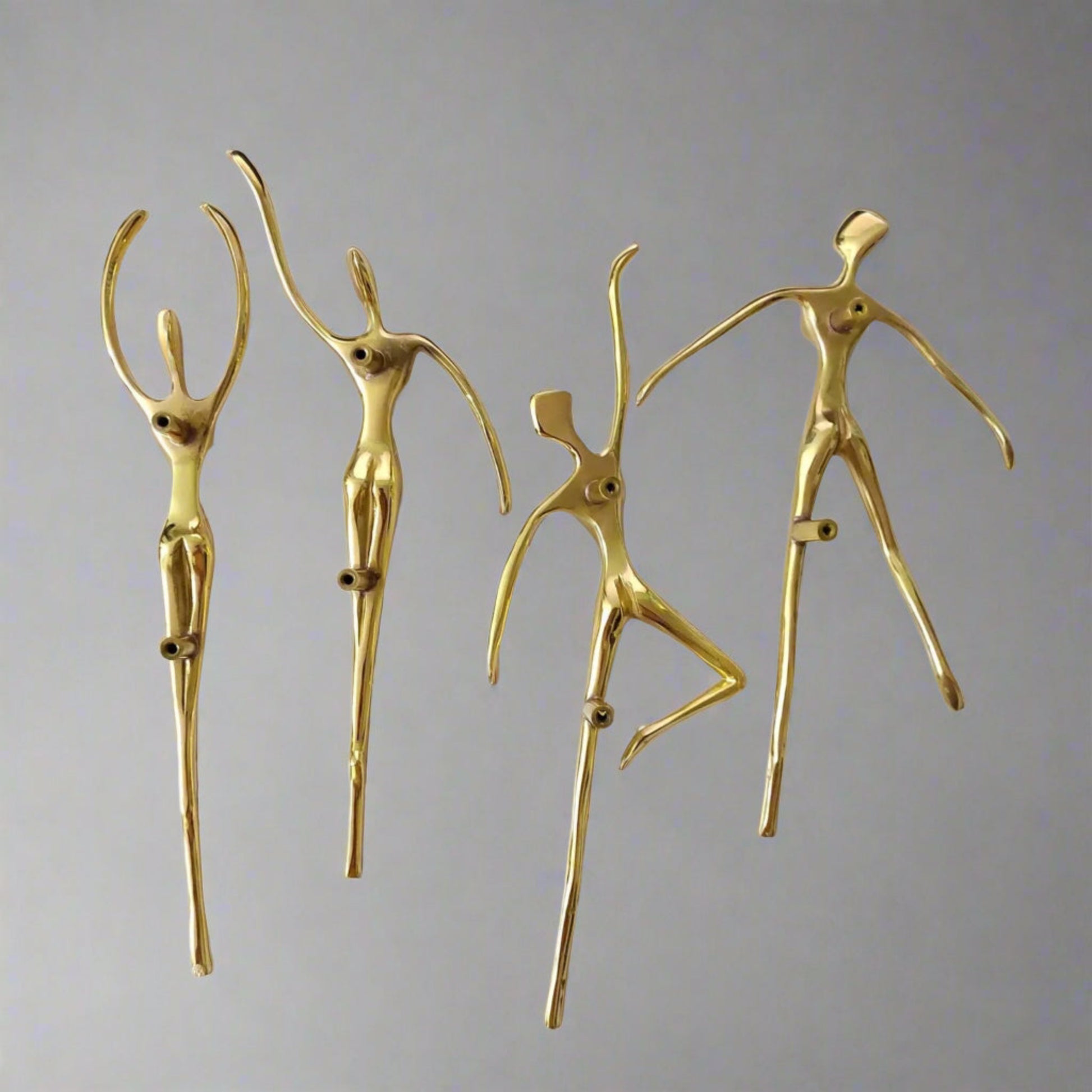 Set of gold cabinet handle figurines on a white background