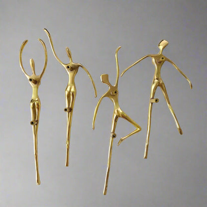 Set of gold cabinet handle figurines on a white background