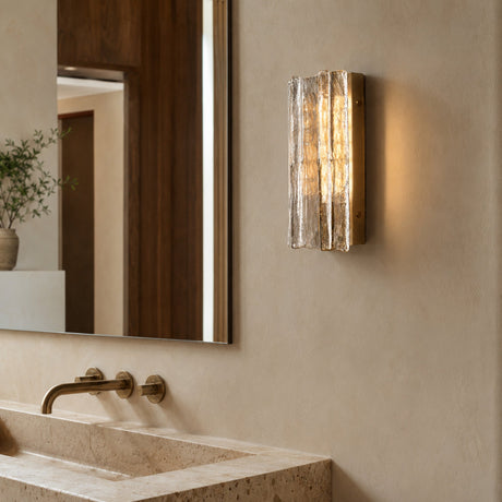 Gold Lattice clear-glass wall sconce installed in a luxury bathroom