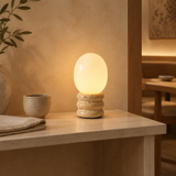 Yellow travertine egg-shaped table lamp in a warm Japandi interior