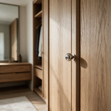Nivara 6312.31T PVD nickel-silver brass cabinet knob installed on natural oak wardrobe cabinetry