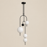 Noctis Black C four-globe pendant cluster on a clean premium beige background