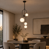 Noctis Black C four-globe pendant cluster in a premium dining interior