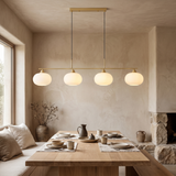 Nordic Linear Globe Chandelier – gold 4-head – dining-room lifestyle