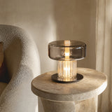 Small Postmodern glass desk lamp styled on a stone side table