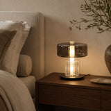 Postmodern glass desk lamp variant styled in a luxury hotel bedroom