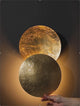 Hand adjusting rotatable Moon Eclipse LED Wall Light. Creative lighting fixture with bronze alloy discs for customizable ambiance.