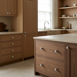 Multiple identical Santaya brushed nickel-silver brass handles installed on luxury cabinetry