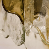 Close-up of a glass pitcher with a gold interior and ice cubes inside.