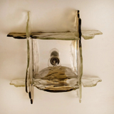 Decorative glass shelf with a light bulb inside on a plain background