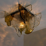 Decorative wall light fixture with glass shades on a neutral background