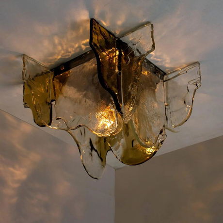 Decorative wall light fixture with glass shades on a neutral background