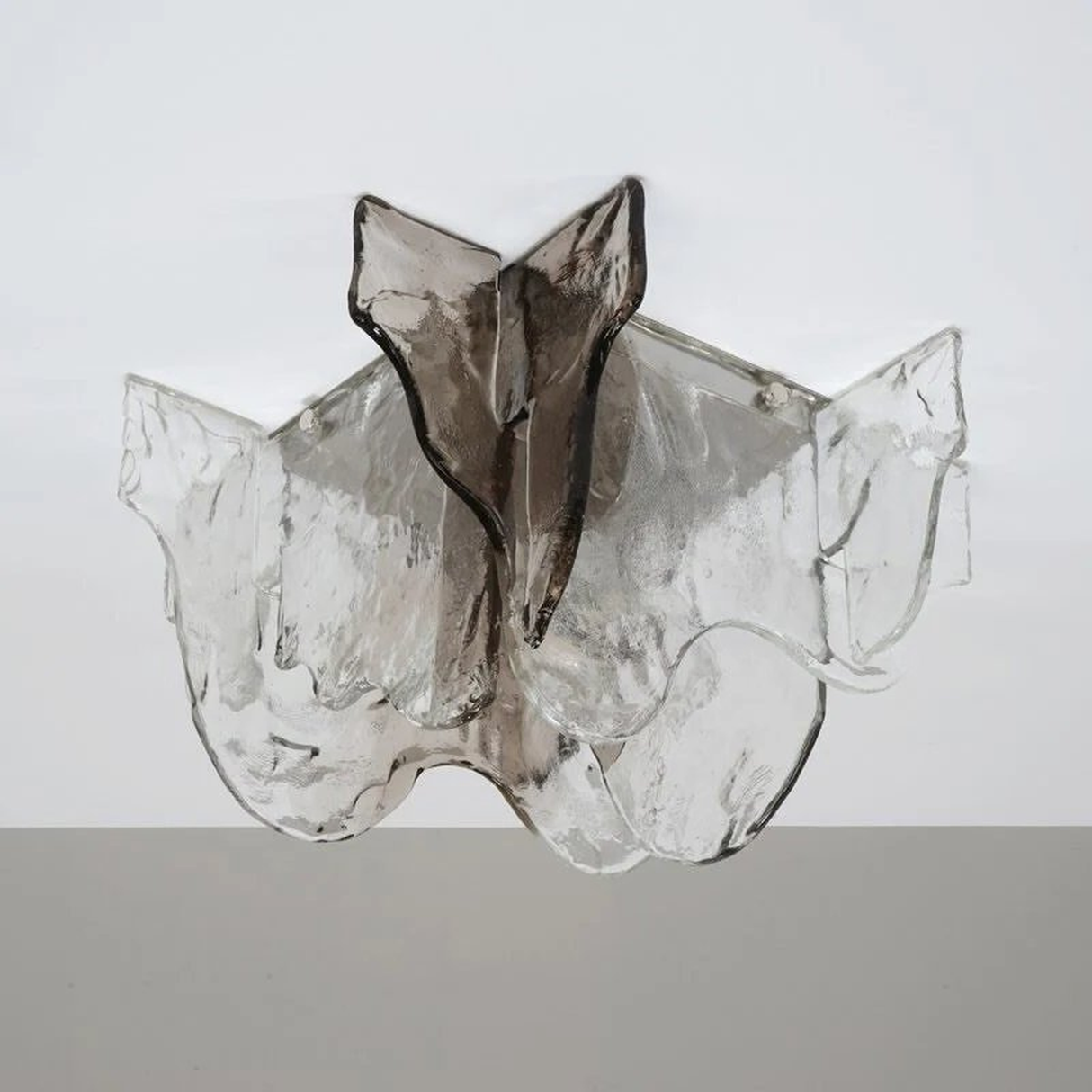 Glass sculpture of a fish on a white background