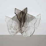 Glass sculpture of a fish on a white background