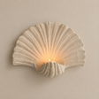 Shell-shaped wall-mounted candle holder on a premium neutral background