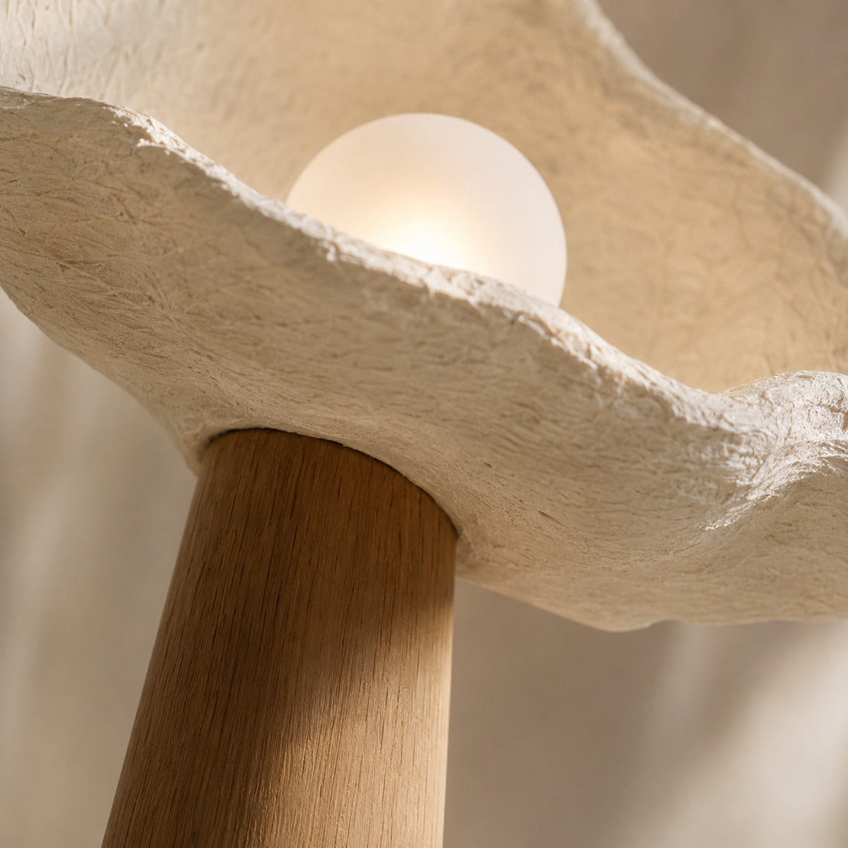 Close-up of the solid-oak column, shell-like shade and frosted globe