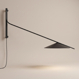 Soren Reach adjustable black LED wall lamp on a beige background