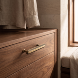 Veyra solid brass medium cabinet pull with knurled antique bronze finish on walnut cabinetry