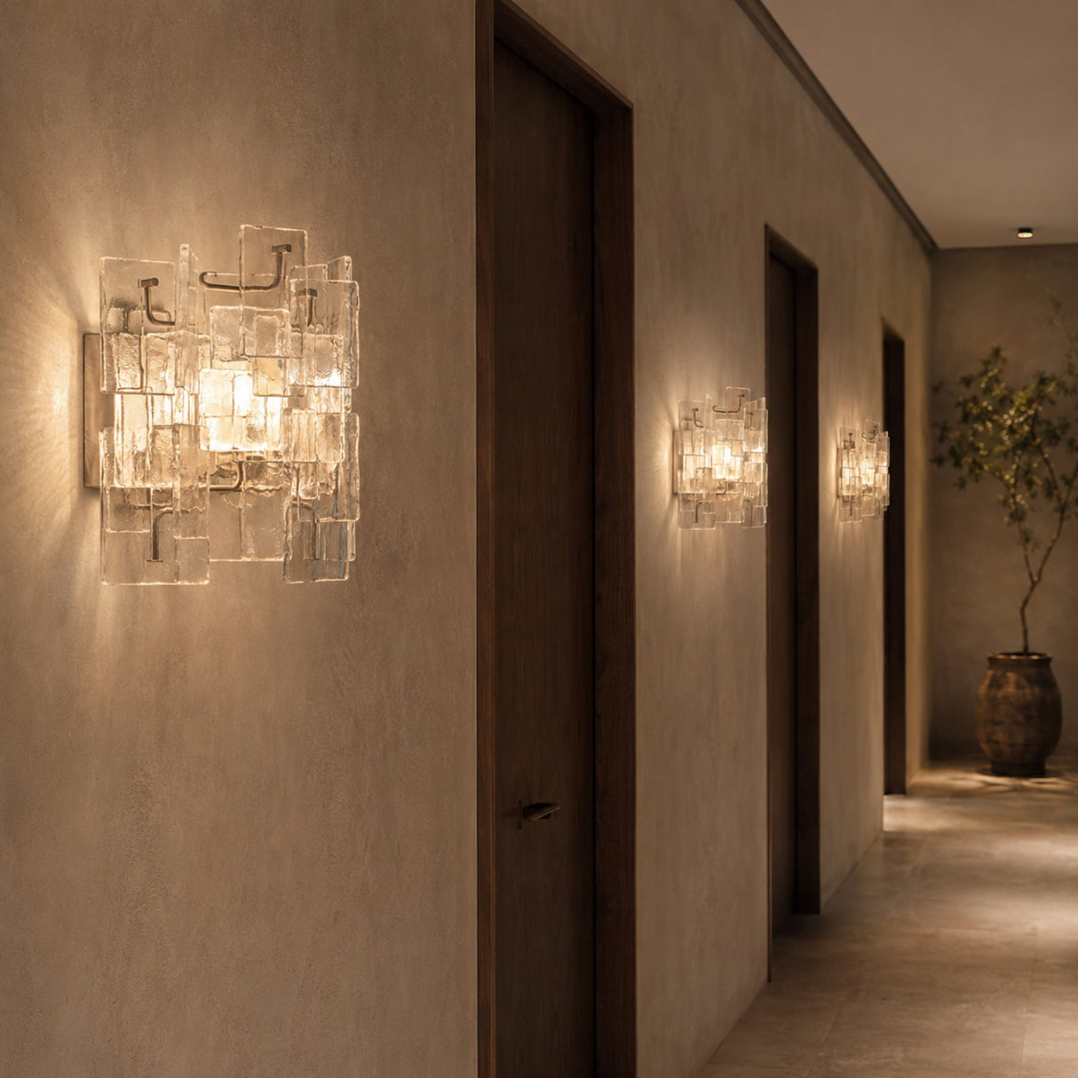 Vintage Medieval transparent glass wall sconces repeated along a hotel corridor