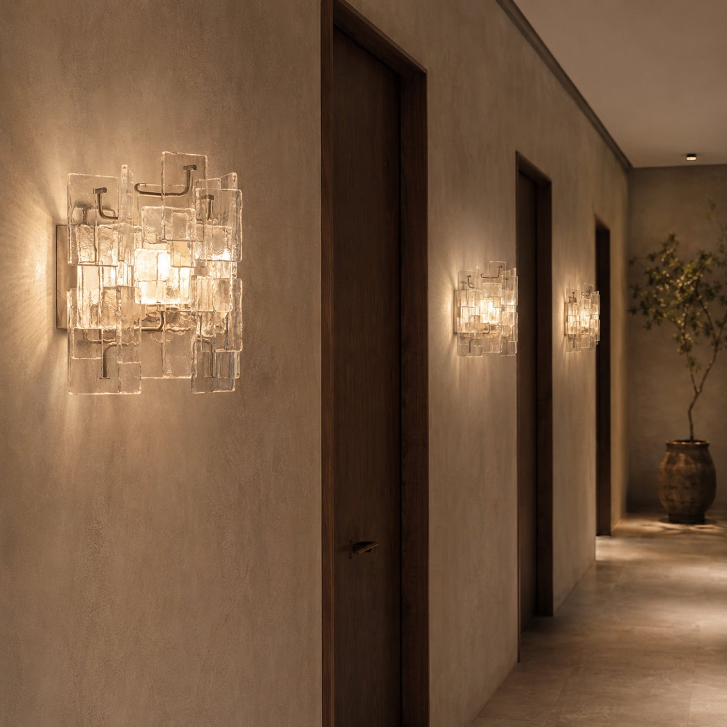 Vintage Medieval transparent glass wall sconces repeated along a hotel corridor